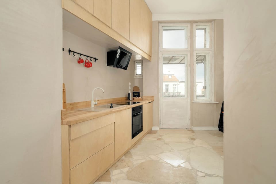 This kitchen is well-appointed with all the necessary appliances and utensils, ensuring that guests have everything they need for cooking.