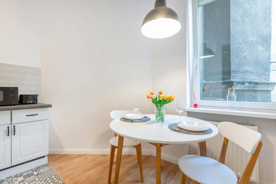 White kitchen area, where the guests can use such appliances as fridge, toaster, freezer, kettle, microwave, and stove.