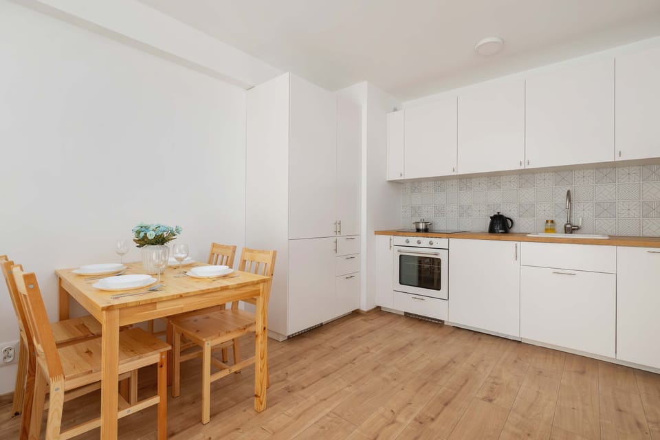 Fully equipped kitchenette with induction cooktop and dining area.