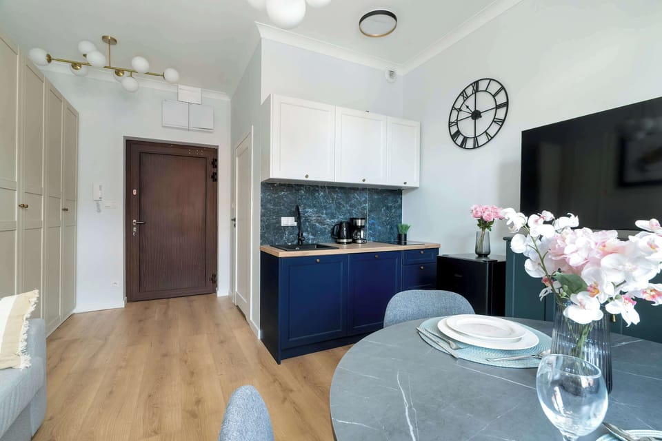 Kitchenette and dining area in the studio decorated with style.