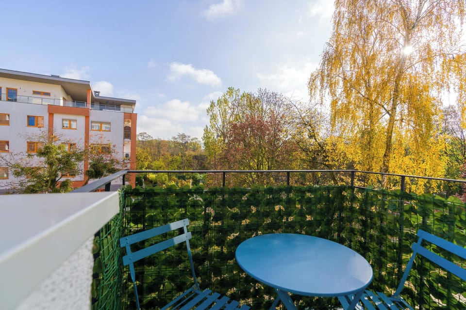 Furnished balcony with green surroundings. 