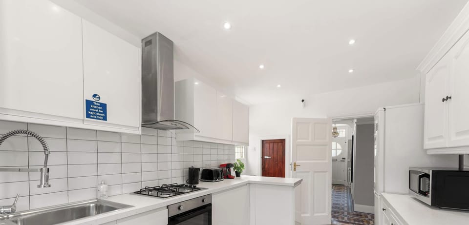 Our full kitchen is bright and all-white, creating a clean and fresh space to cook, enjoy meals, or gather with friends and family.