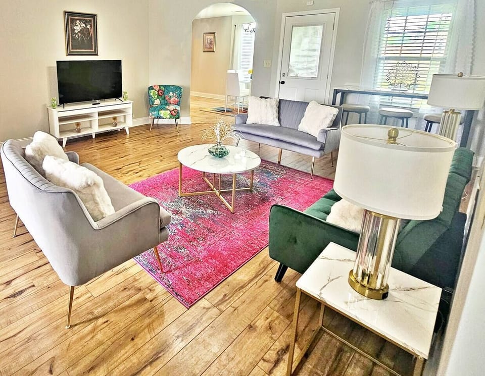 Kick back, relax in this comfy living room, and watch your favorite movie or show on the 55-inch flat-screen smart TV. The green sofa is the sleeper sofa!
Step out the door to the back patio & fenced-in backyard. 