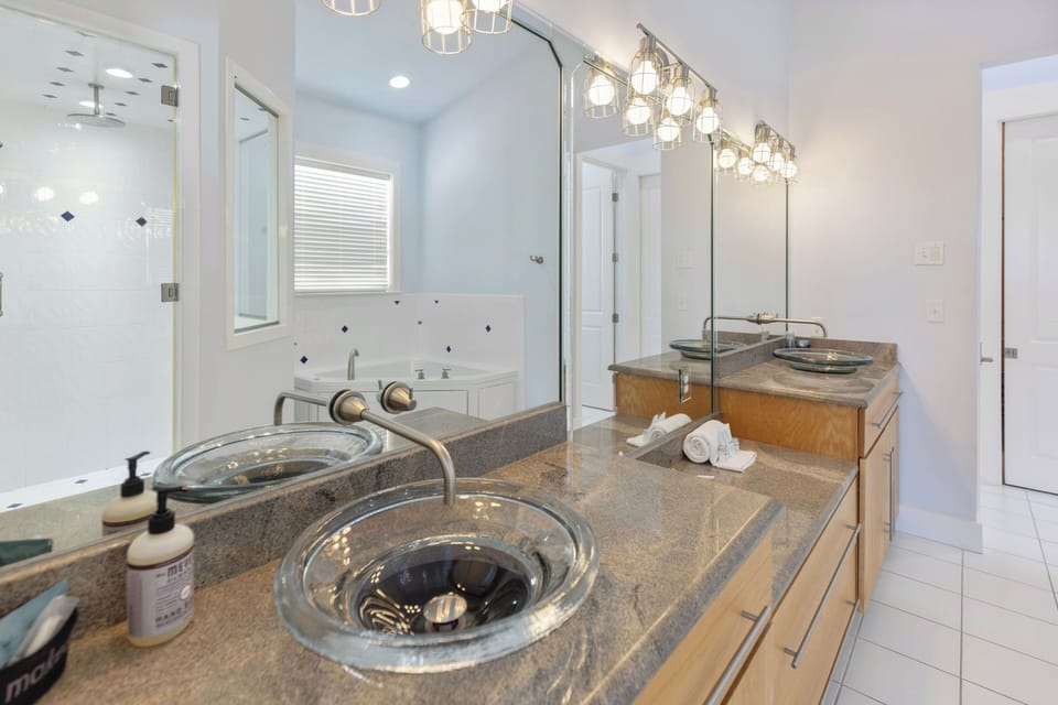 Indulge in your spacious master bathroom featuring elegant pendant lighting and luxurious granite counters.