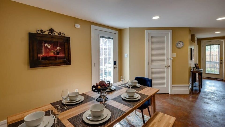 Dining space with table set and ready for meals.