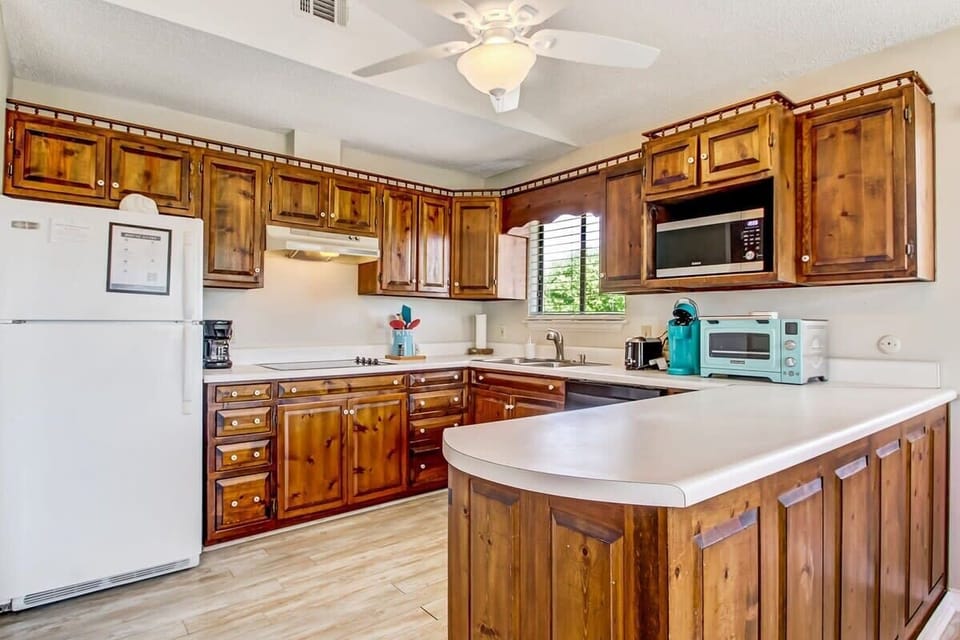 Beautiful kitchen with rich wood cabinetry and plenty of space for meal prep.