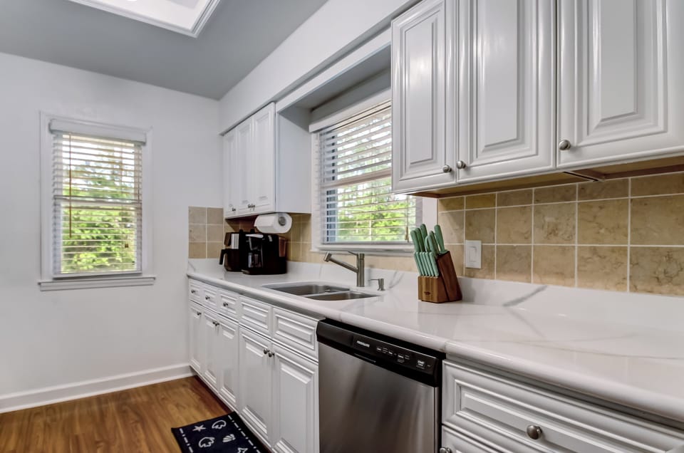 Kitchen workspace with white countertops and plenty of prep space.