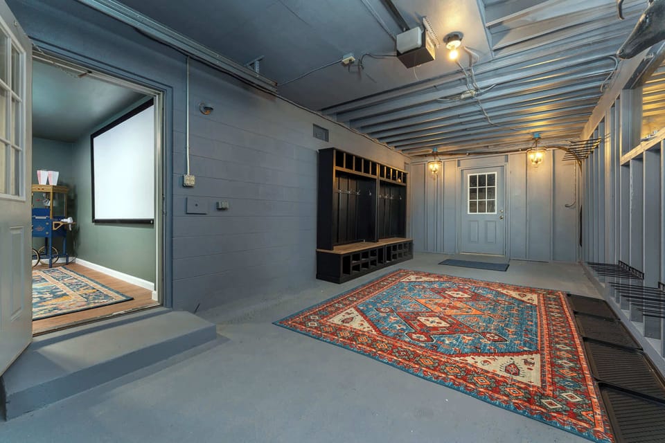 And yes, it also doubles as a private movie theater with 6 plush recliners, a popcorn machine, and a projector setup for the ultimate movie night experience.