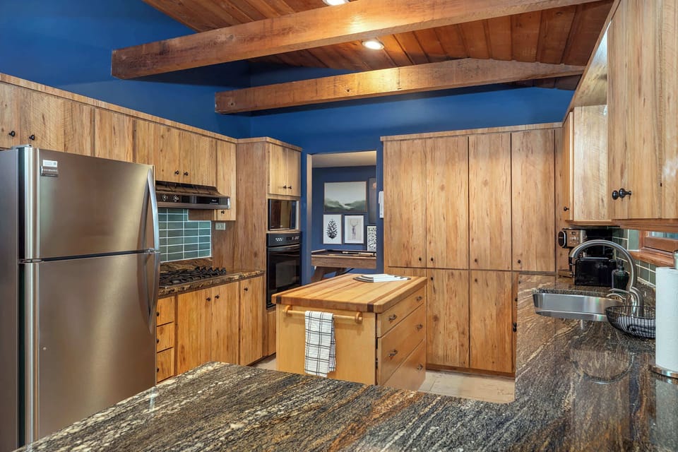 Features high-end appliances and a spacious island—perfect for meal prep, casual dining, or gathering with friends and family.