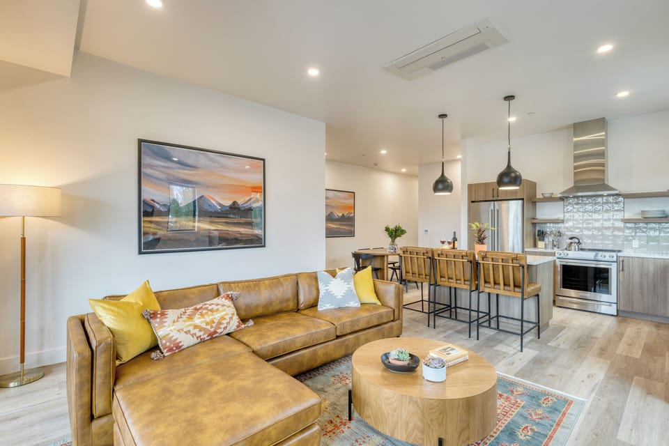 Bright living area with balcony access and smart TV.