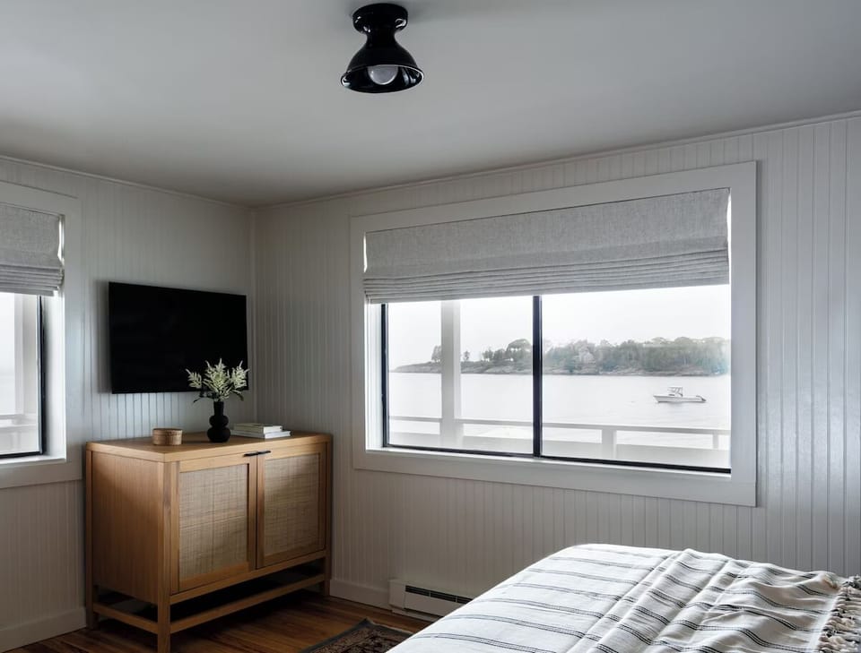Wake up to serene water views from your bed.
