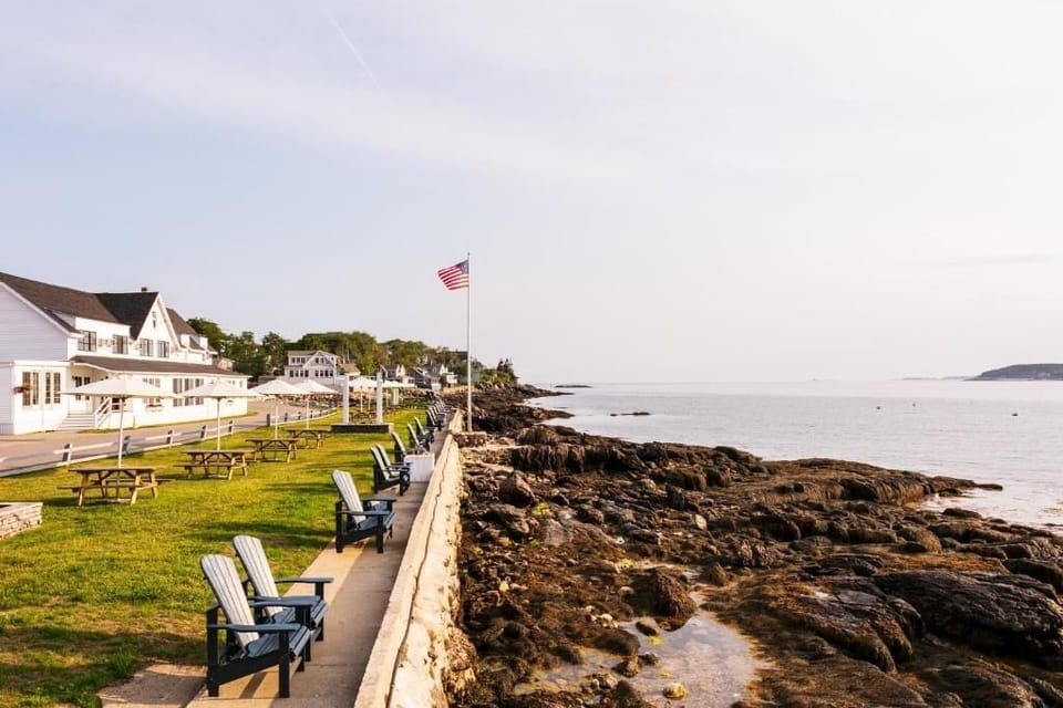 Unwind on Adirondack chairs beside calming, rocky shoreline views.