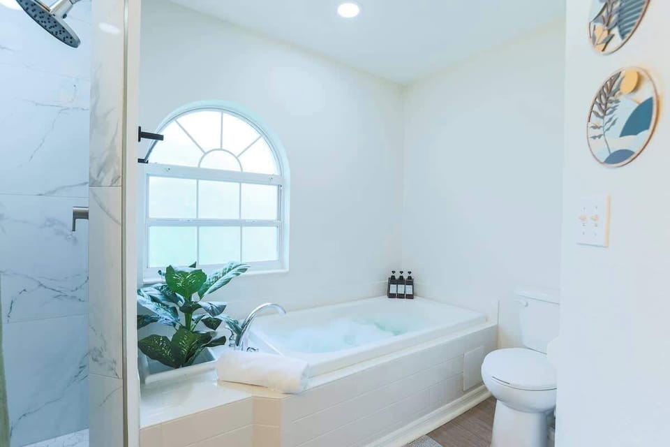 Indulge in a spacious en-suite featuring a soaking tub, walk-in shower, and dual vanities—your private spa retreat right at home.