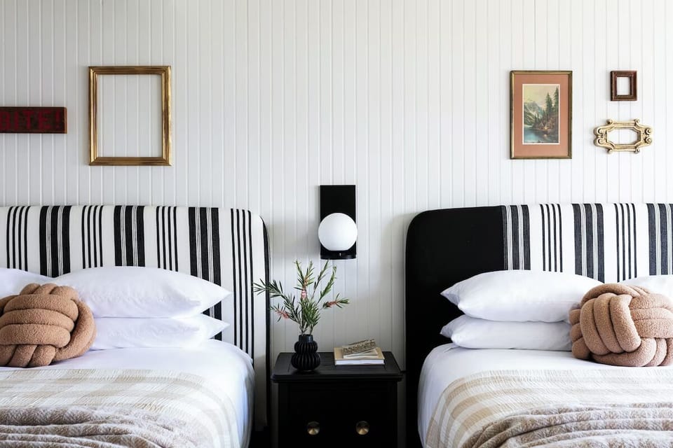 Settle in with layered textures and crisp, cloud-like bedding.
