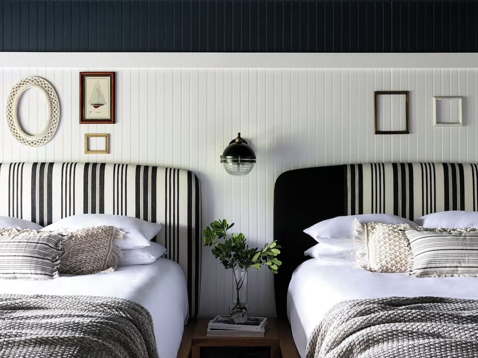 Drift off in twin beds styled with boutique-hotel comfort.