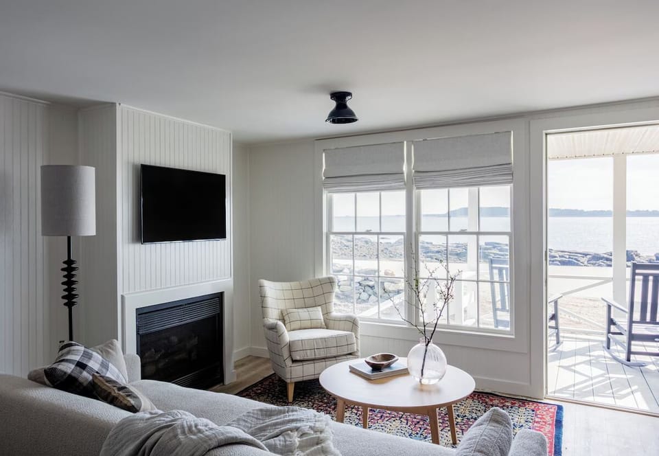 Unwind on the sofa with bright windows and ocean views.