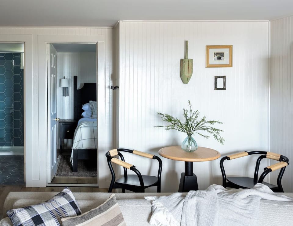 Sip morning coffee beside cozy seating, steps from bed.
