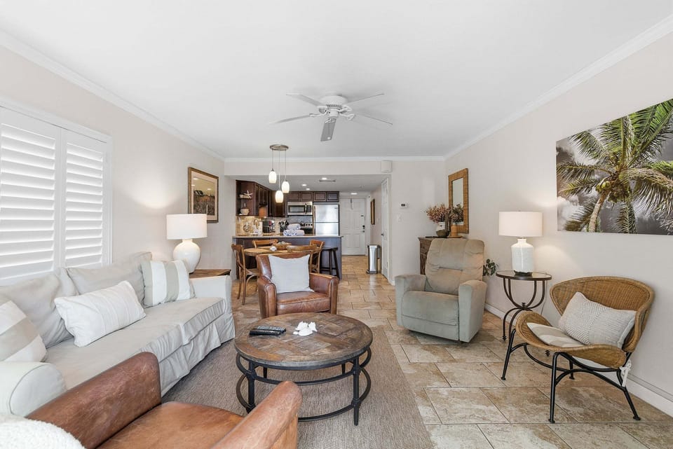 Enjoy a relaxing beach stay in this open-concept coastal condo featuring comfortable seating, beach-inspired décor, and easy access to the dining area and kitchen. Perfect for family beach vacations and seaside escapes.
