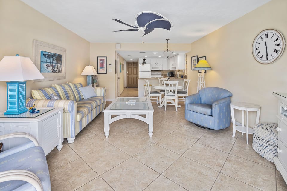 Enjoy open-concept living with coastal décor, comfy seating, and a dining area—perfect for relaxing after a day at the beach or sharing meals during your seaside vacation.