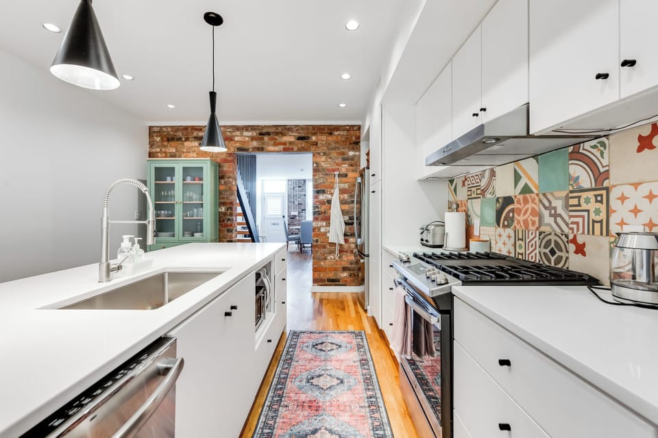 Kitchen: Modern design with vibrant tiles and sleek appliances for your culinary creativity!