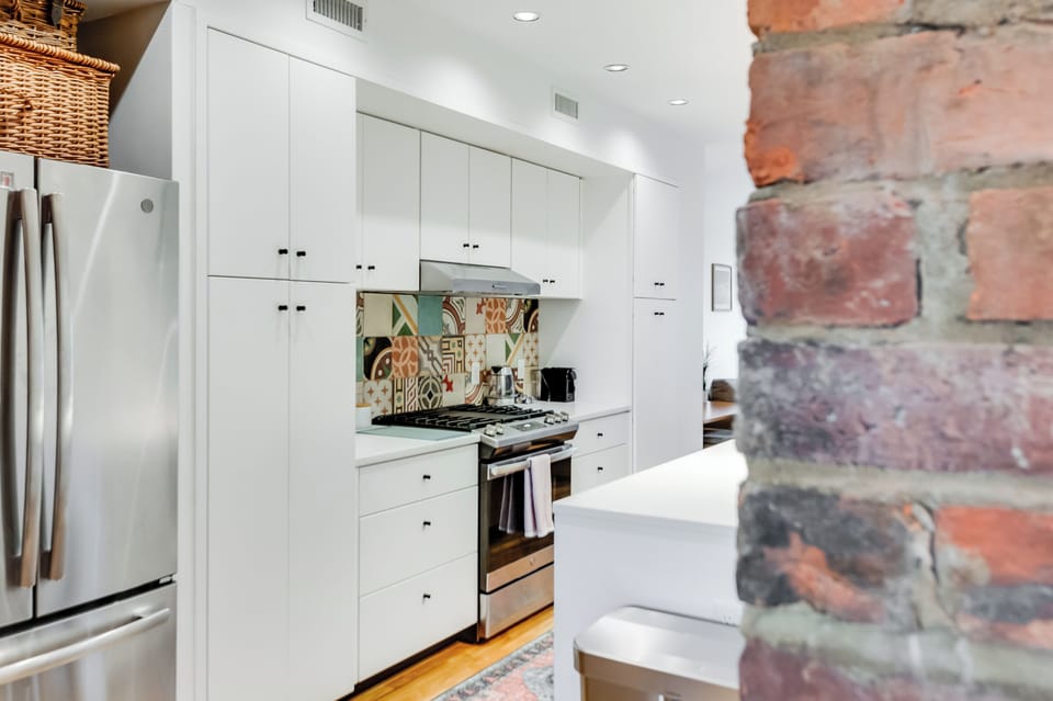 Kitchen Delight: Modern appliances and colorful backsplash inspire culinary creativity!