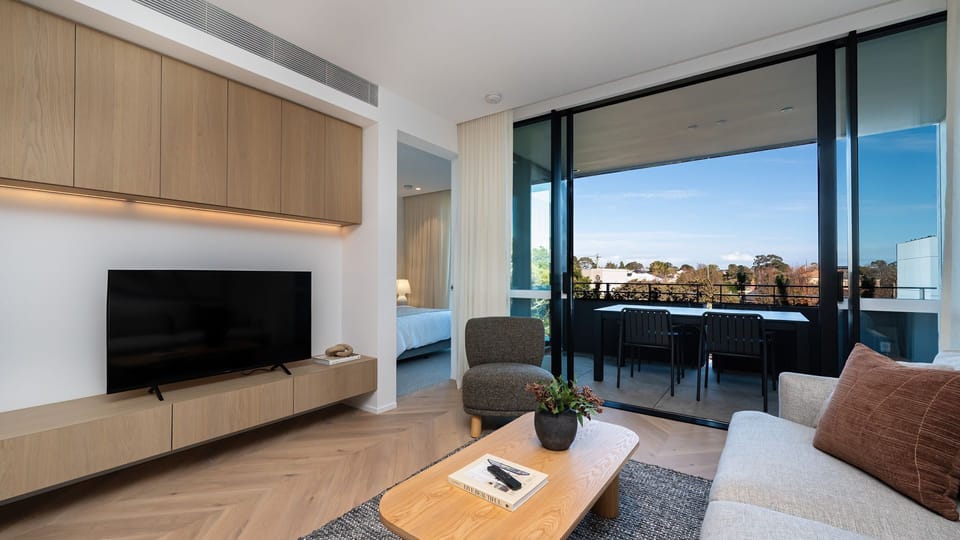 Living with smart Tv and access to private balcony for outdoor dining 