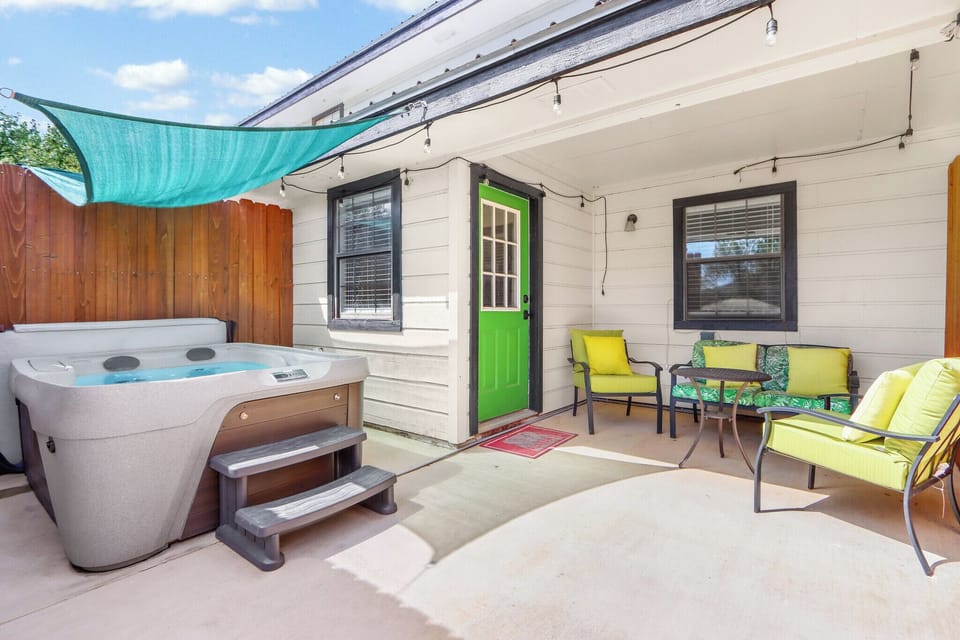 Private outdoor space with seating and a hot tub