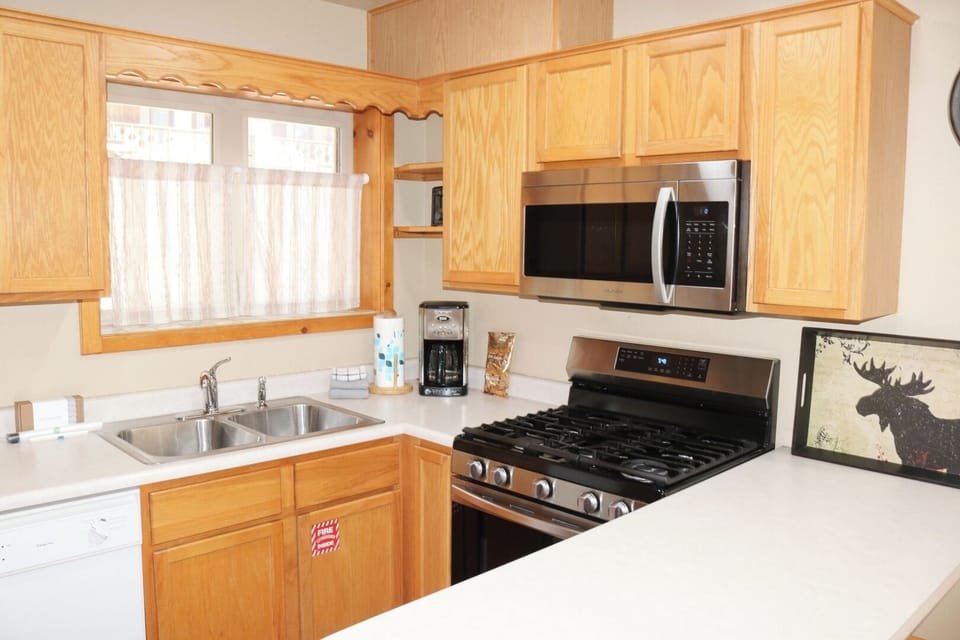 Your fully equipped kitchen features stainless steel appliances, a gas stove, microwave, and coffee maker—perfect for preparing meals and morning coffee during your stay.