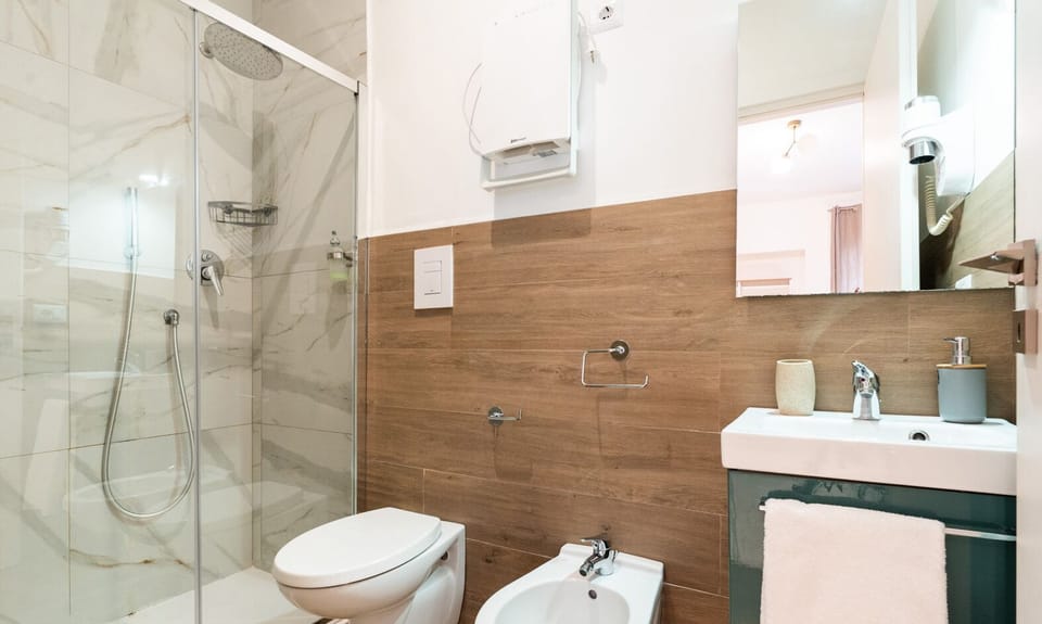 Double Room | Bathroom | Shower, hair dryer, bidet, towels