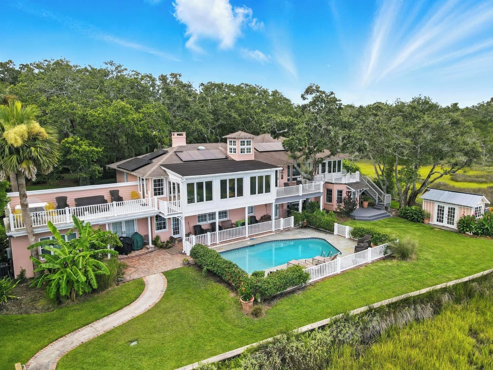 Backyard Pool, Marshside Walkway, and Upper Sun Decks - This wide-angle view highlights the seamless blend of indoor and outdoor living—private pool, rooftop sun decks, marshside boardwalk, and a canopy of ancient oaks.