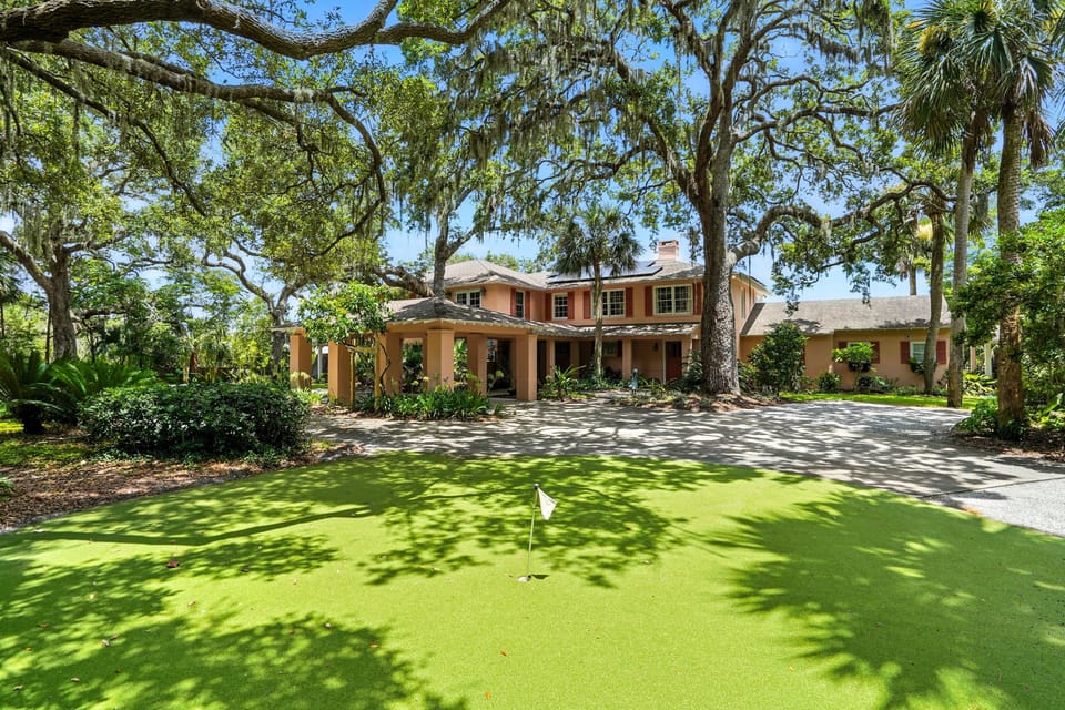 Front Lawn Putting Green Under Live Oaks - The front lawn includes a private putting green beneath mature live oaks.