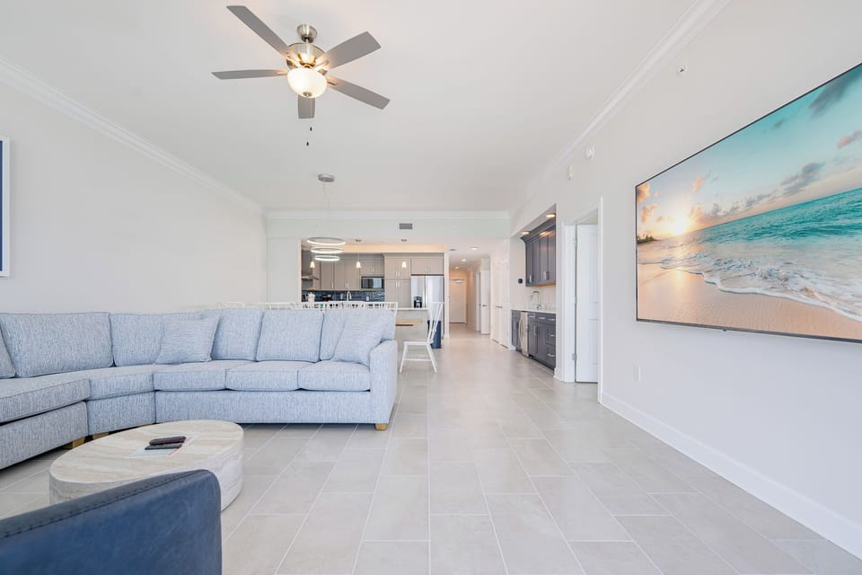Relax on the cozy sofa while enjoying the large TV and an inviting atmosphere throughout the living area