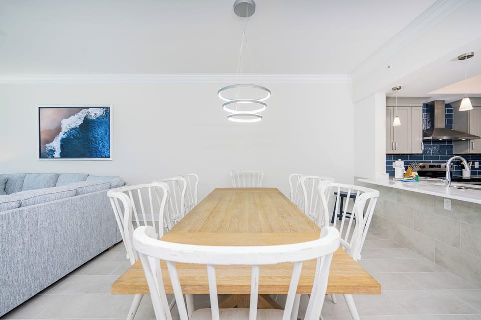 Gather around the dining table, surrounded by chairs, perfect for family meals