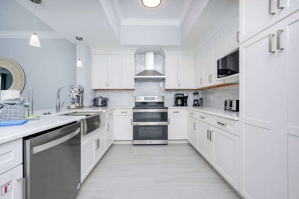 Prepare meals in this stylish kitchen featuring sleek cabinetry, stainless appliances, and elegant accents