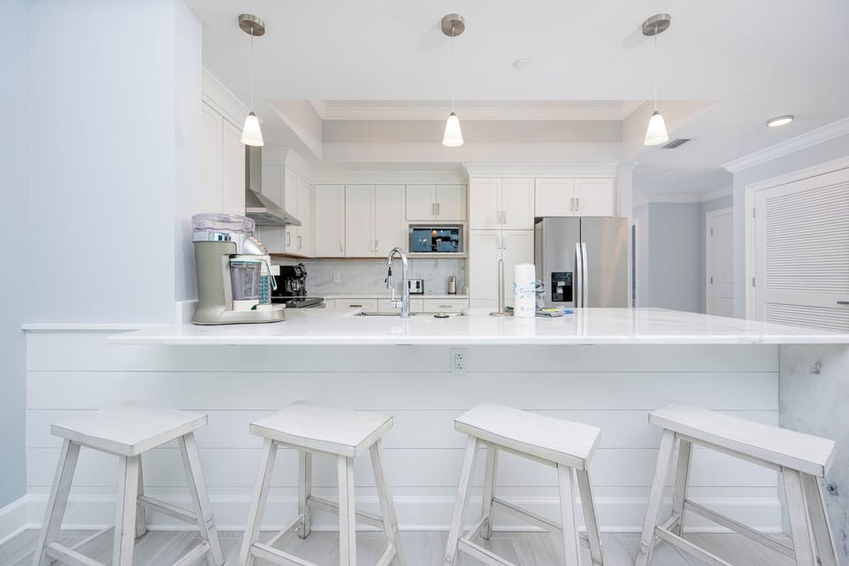 Gather around the sleek kitchen, perfect for casual meals or morning coffee during your stay