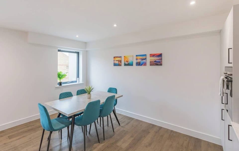 An elegant dining area with a stylish table, comfortable chairs, and ambient lighting, perfect for meals and gatherings.