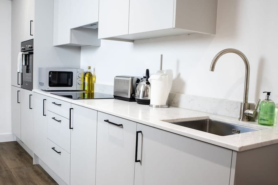 A spacious kitchen featuring polished surfaces, state-of-the-art appliances, and plenty of cabinetry for a seamless cooking experience.
