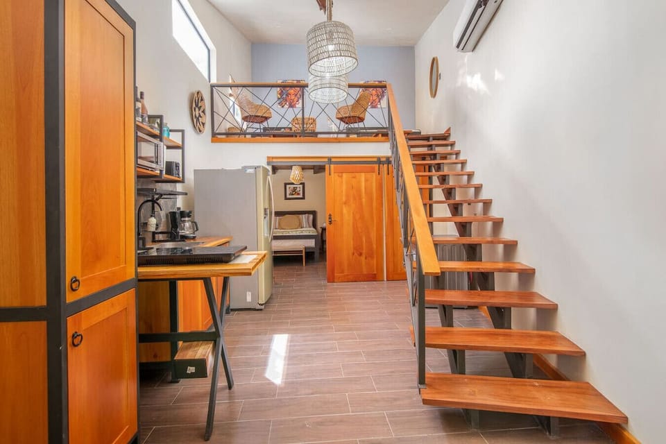 Open-concept kitchen with warm wooden finishes, modern appliances, Aloki Wim 4 in Playa Chiquita