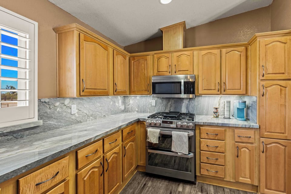 Fully stocked and ready to cook! This kitchen has it all—from pots, pans, and utensils to an Instant Pot, blender, toaster, and waffle maker. Coffee lovers can choose between a traditional machine, French press, or grinder. Dual Stoves. 