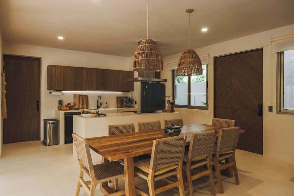 Dining table and fully equipped kitchen.