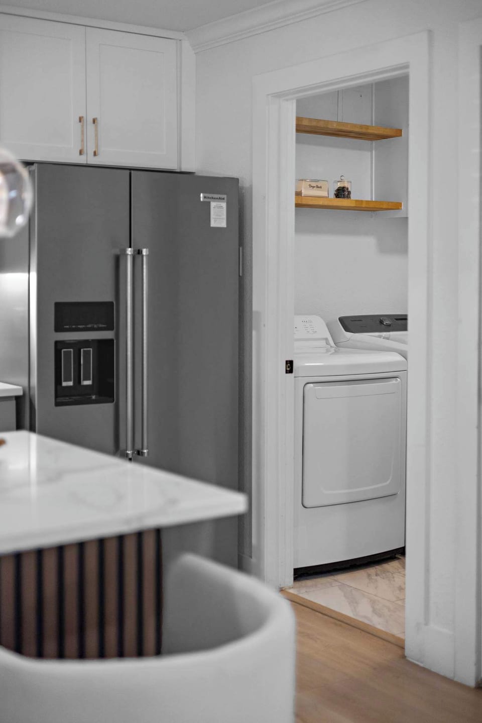Large refrigerator for your food and drinks with adjacent laundry room with washer and dryers for your laundry needs.
