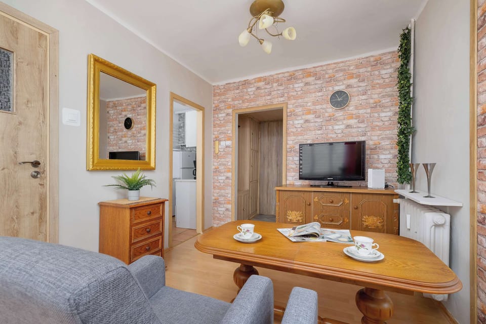 Stylish studio featuring dining area, comfortable seating, TV, and charming decorative details.