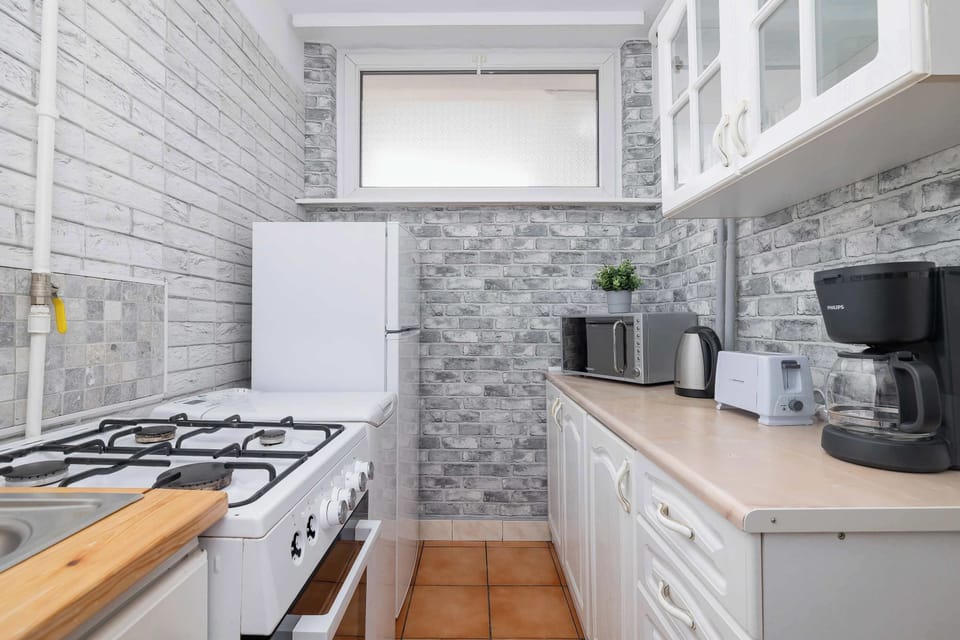 Bright kitchen with modern cabinetry, wooden countertops, and practical layout for everyday cooking.