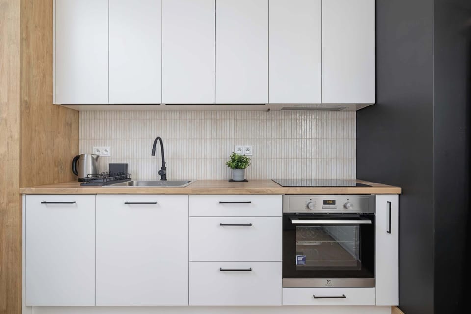 Kitchenette with oven and refrigerator. 