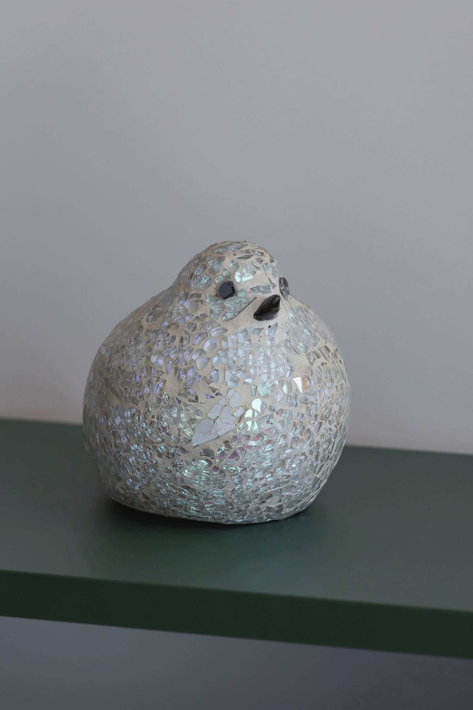 A decorative ceramic bird figure adding charm to the studio’s interior.