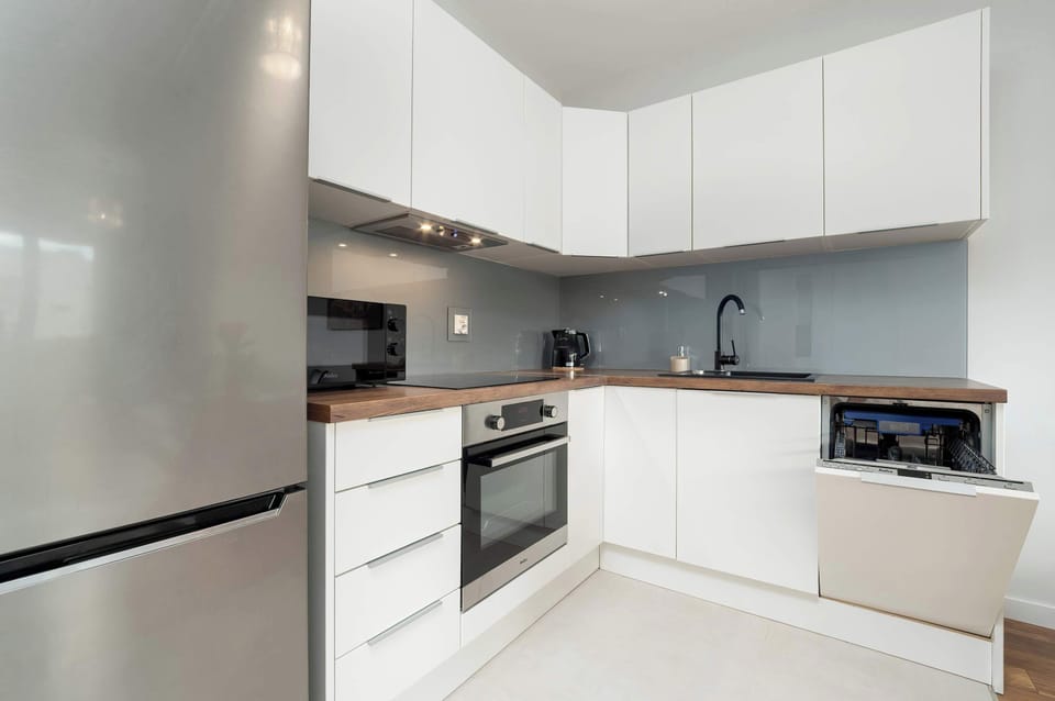 A thoughtfully designed kitchen with a functional layout, elegant cabinetry, and subtle lighting ensures cooking comfort.