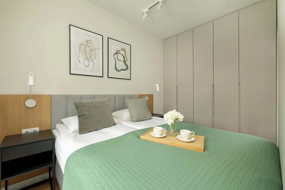 Bed area viewed from the opposite side, highlighting the integrated studio layout.