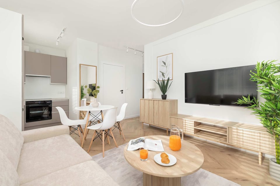 The living room also features a shelf for storage and decor, complementing the Smart TV and seating area.