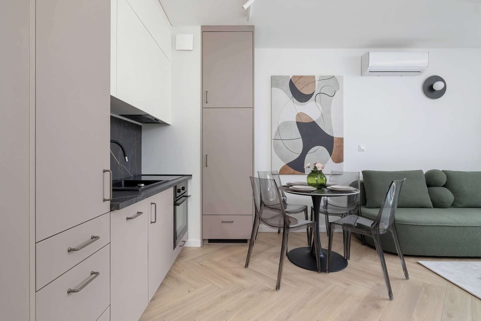 The sleek design of the kitchenette blending seamlessly with the living area.