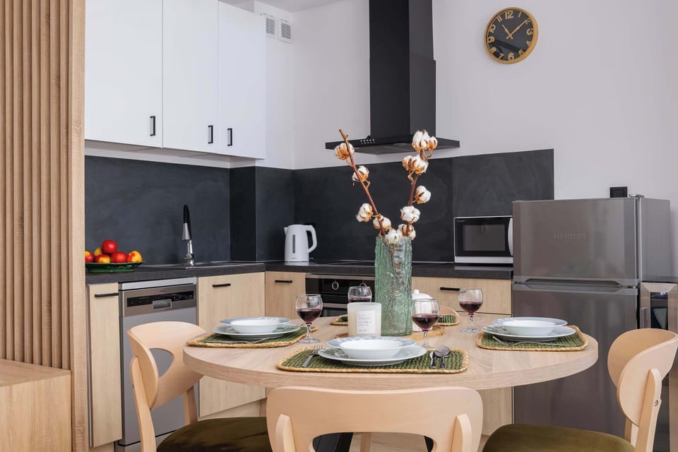 Fully equipped kitchenette with electric hob, oven, refrigerator with freezer, microwave, electric kettle, coffee maker, dishwasher, toaster and dining area.